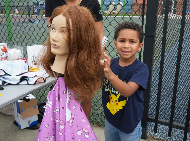 Kovian Hack, a student in the Sussex Consortium’s Little Vikings program, practices his hairdressing skills on a mannequin at the Bad Hair Day? Rehoboth station at the fourth annual Community Helper Day, held at the Sussex Consortium Sept. 26. ELLEN MCINTYRE PHOTOS
